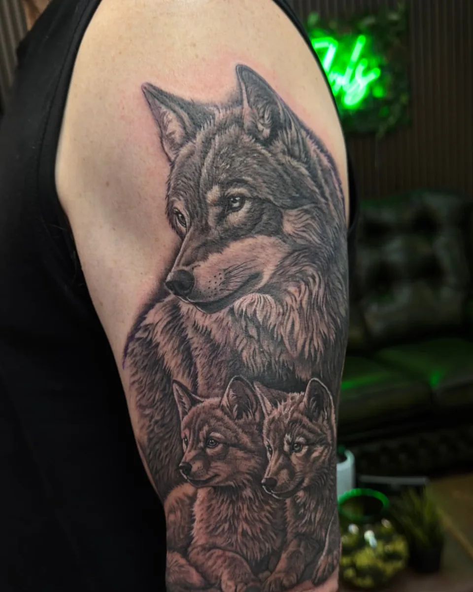 Wolf and cubs upper arm tattoo