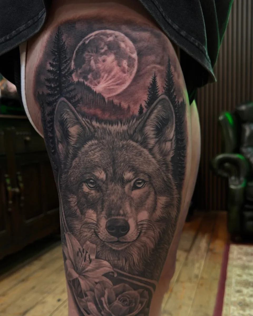 Wolf under full moon thigh tattoo
