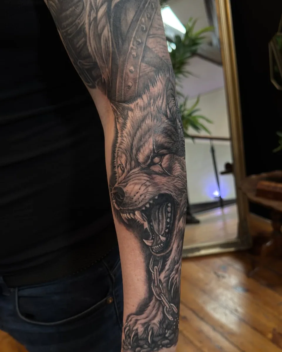 Snarling chained wolf forearm sleeve